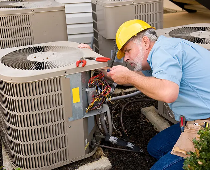technician repairing ac unit in maryville illinois